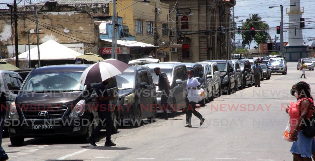 In this file photo, mini vans taxis wait for passengers in  Broadway Port of Spain for the Chaguanas route. - SUREASH CHOLAI