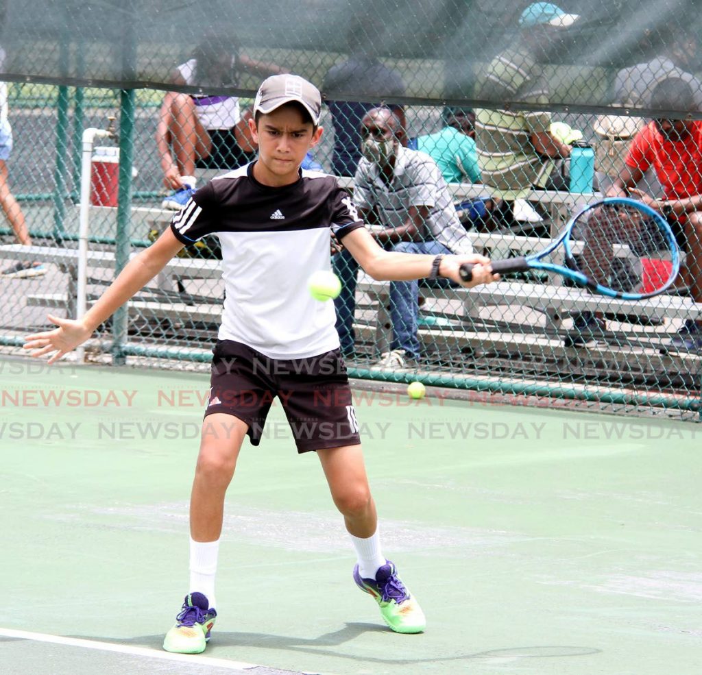 Kale Dalla Costa looks to play a return against Isaiah Boxill, during the boys 14 and under semi-final match, at the Catch National Junior Tennis Championship, at Nelson Mandela Park, St Clair, on Thursday. - Angelo Marcelle