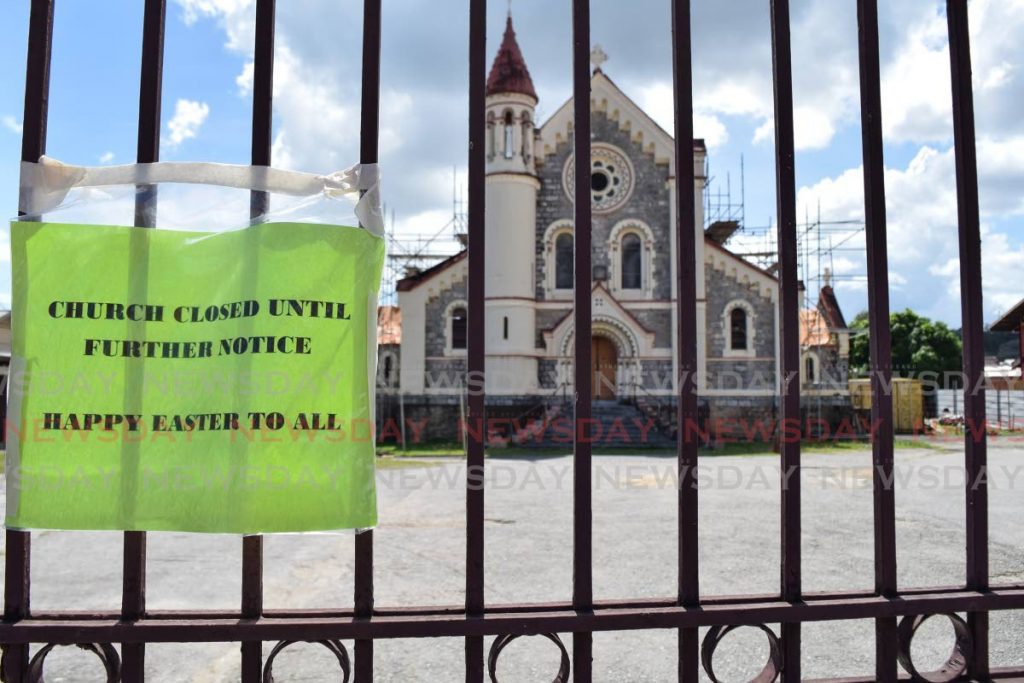 A sign on the gates of St Francis RC Church, Belmont says the church is closed until further notice. It also wishes all a Happy Easter. The parish says two covid19 cases led to the closure. - Photo by Vidya Thurab