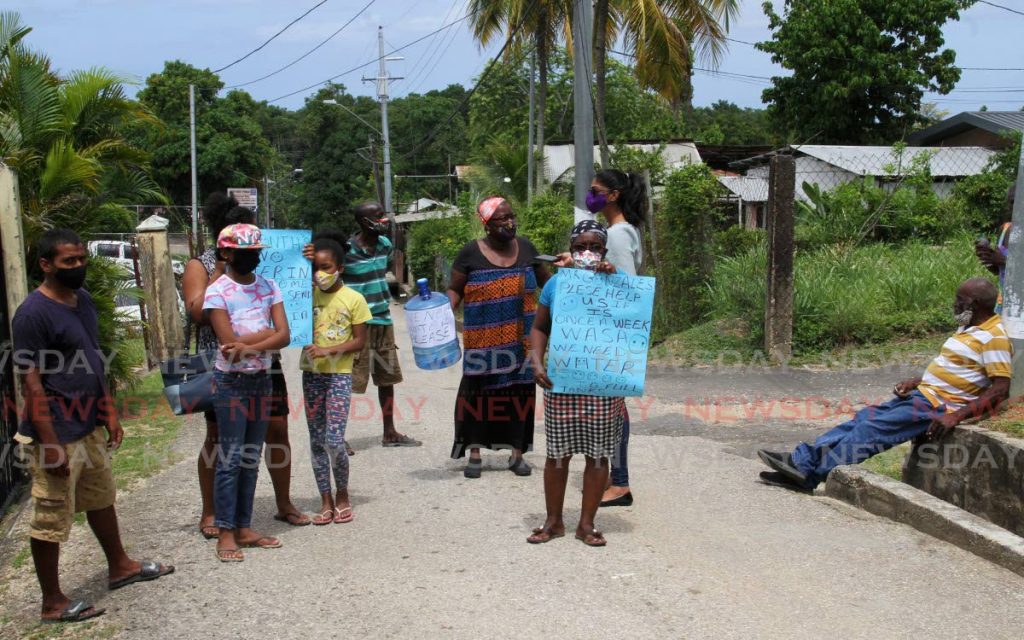 Residents of Rosehill St. Southern Main Road, Claxton Bay, protest their lack of pipe-bourne water for over three months. File photo by Angelo Marcelle