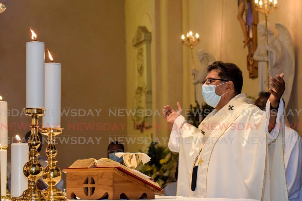 File photo: Archbishop Jason Gordon prays during Mass on Easter Sunday at the Cathedral of the Photo by Vidya Thurab