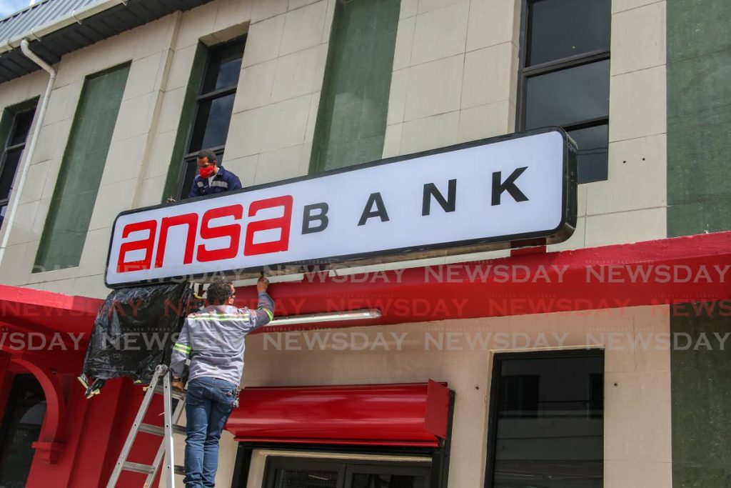 REBRANDED: Workmen install new sinage for Ansa Bank which recently bought out Bank of Baroda. The rebranding exercise began in San Fernando on Monday and will continue in Port of Spain and Chaguanas this week. Photo by Jeff K. Mayers  