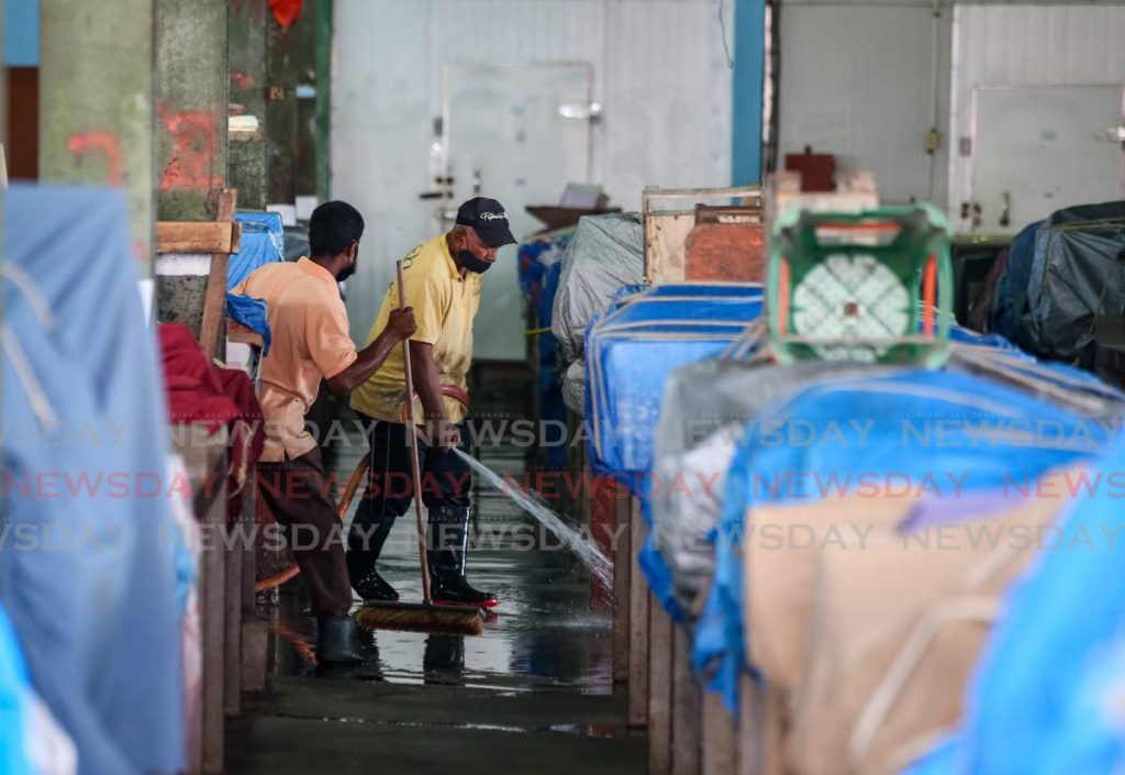 Workers were busy on Monday washing down parts of the Chaguanas Market for its reopening today.  - Jeff K. Mayers