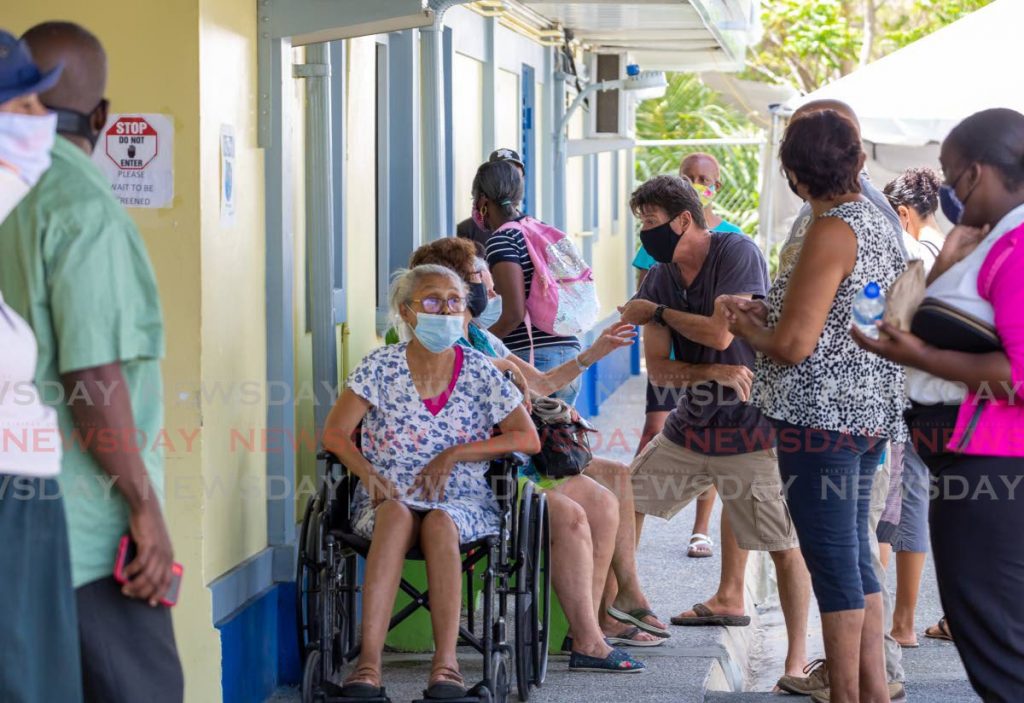 FILE PHOTO: Members of the public wait for their covid19 vaccine at the Canaan Health Centre, Tobago, on April 7. - David Reid
