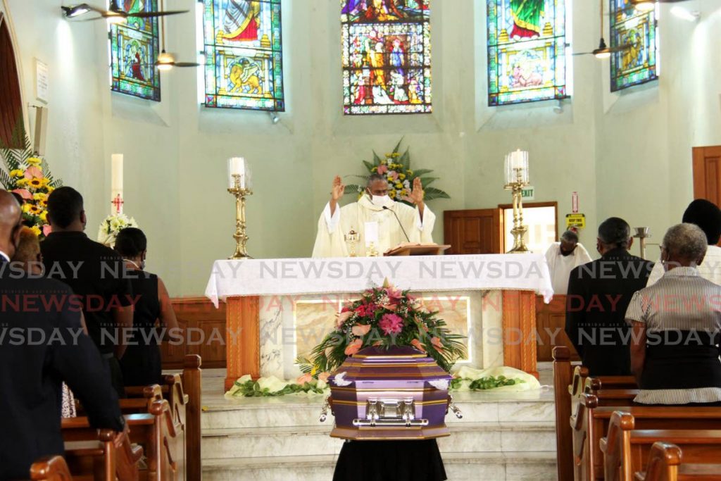 Fr Steve Duncan prays at the funeral for former independent senator Dame Louise Horne at the Santa Rosa RC Church, Arima on Wednesday. - AYANNA KINSALE