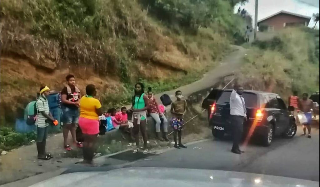 In this photo, residents of communities in northeast St Vincent, around the La Soufriere area, on trucks and at the side of the road waiting for rides to safer areas on Thursday evening. 