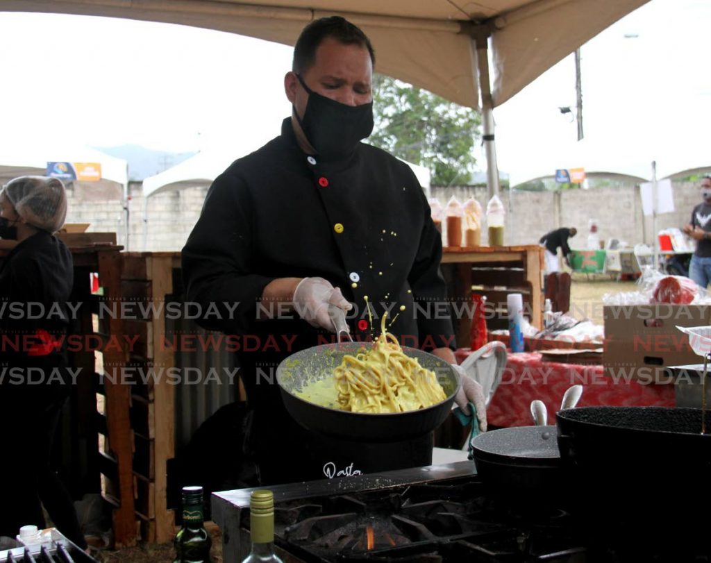Chef Wilmer Escalona prepares curry coconut alfredo with shrimp at the launch of Flavourama Festival onApril 9 at Barbados Road, Federation Park. Photo by Ayanna Kinsale
