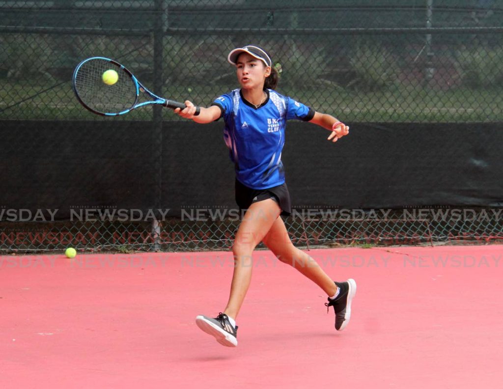 Jordane Dookie makes a return to Aalisha Alexis during the  women’s A division singles final at the the East Clubs Classified Tennis Tournament at the Country Club, Maraval, on Saturday.   Alexis won 7-6,6-3.  - AYANNA KINSALE
