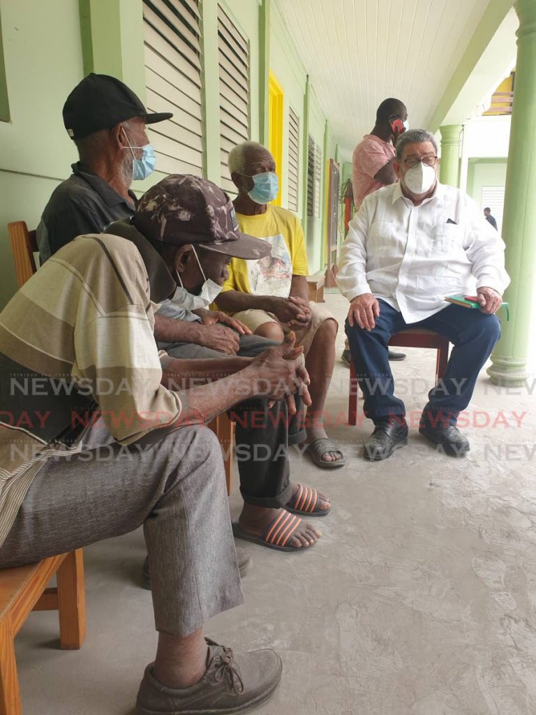 Prime Minister Dr Ralph Gonsalves sitting with senior citizens who had to evacuate their homes at the Thomas Saunders Secondary School in Kingstown, which has been turned into an emergency shelter. PHOTO COURTESY SEARCHLIGHT NEWSPAPER, ST VINCENT - SEARCHLIGHT NEWSPAPER