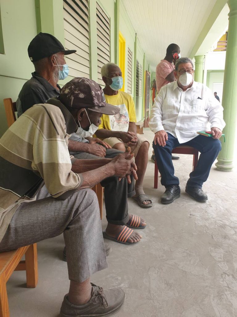 St Vincent Prime Minister Dr Ralph Gonsalves sits with senior citizens, who had to evacuate their homes, at the Thomas Saunders Secondary School in Kingstown, which has been turned into an emergency shelter. Trauma specialist Hanif Benjamin says measures must be put in place to help Vincentians to deal with the stress and shock of how they have been displaced by the eruption of La Soufriere volcano. Photo courtesy Searchlight newspaper.  - 
