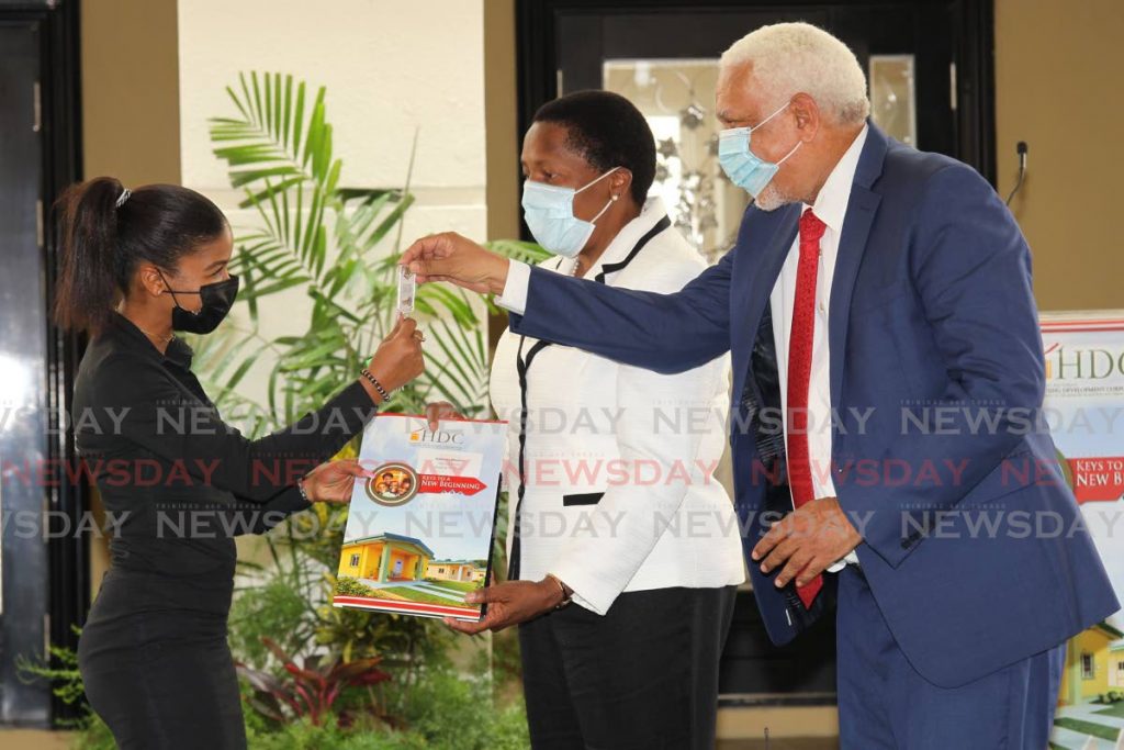 In this file photo, Kadisha Munroe, left, receives the keys to her new HDC home in Riverside North, Corinth on Monday from Housing Minister Pennelope Beckles and HDC chairman Noel Garcia. - Photo by Lincoln Holder