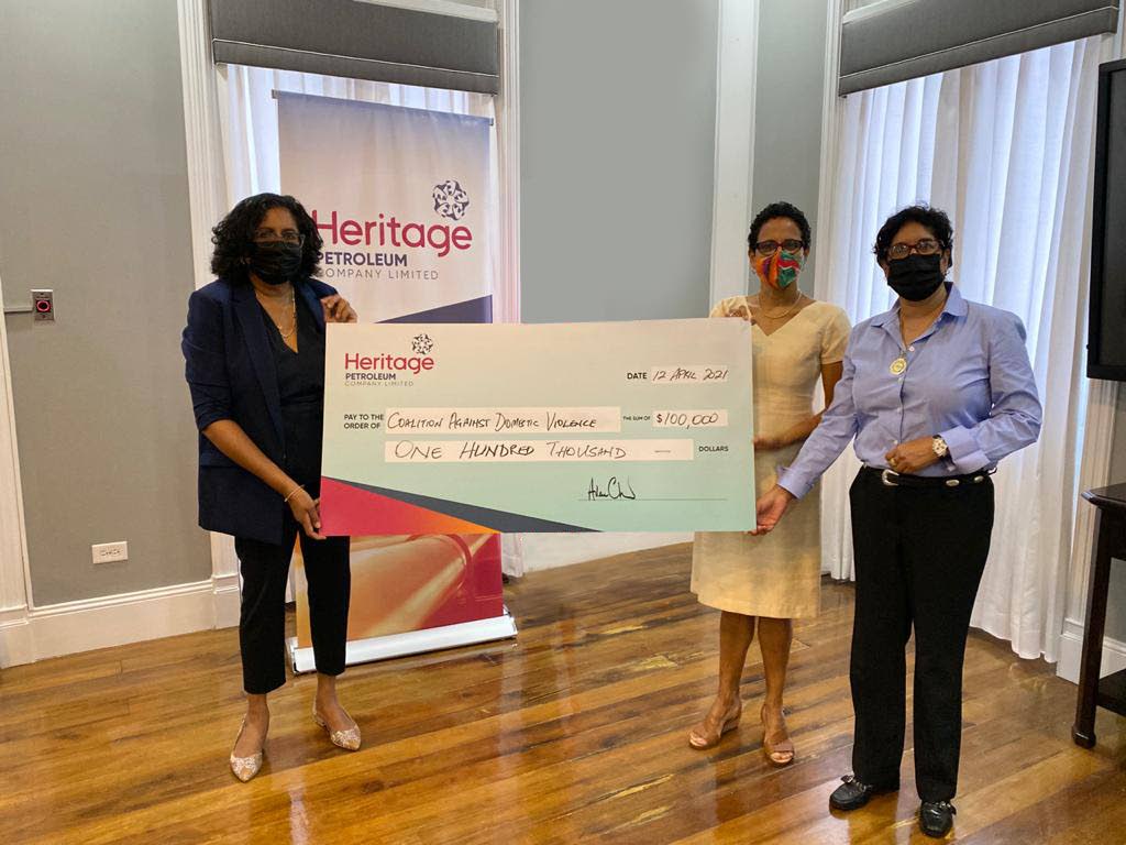 From left to right, Heritage CEO Arlene Chow holding the ceremonial cheque with CADV’s Roberta Clarke and Reshma Saith. - Photo courtesy Heritage Petroleum