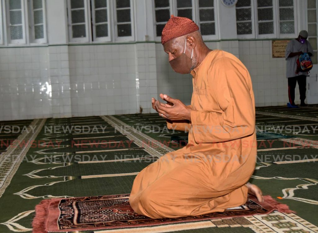 Khalid Ferdinand prays at the Queen Street mosque in Port of Spain last Wednesday evening. Photo by Vidya Thurab - 