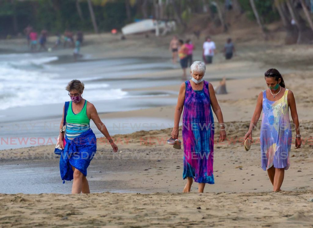 Beachgoers at Mt Irvine's Beach on Wednesday before a ban announced by the Ministry of Health kicks in at midnight. - DAVID REID
