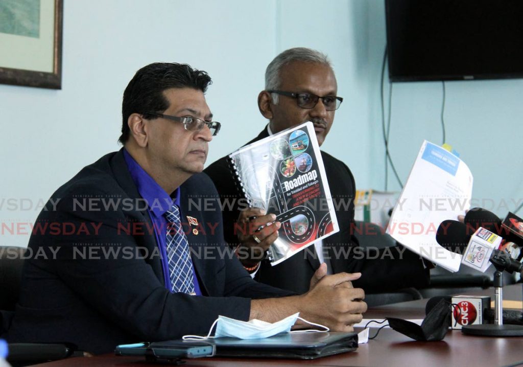 Mayaro MP Ruston Paray (left) and Couva South MP Rudranath Indarsingh speak to reporters on Sunday at the Office of the Leader of the Opposition, Port of Spain. - Angelo Marcelle