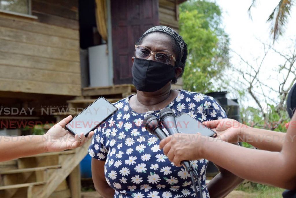 Dianne Paul, the neighbour who found the body of Utilda Joseph recounts to the media the ordeal of finding Utilda's body on Saturday night at Hillview Lane extension, Quarry Village, Siparia, on Sunday afternoon. Photo by Vidya Thurab