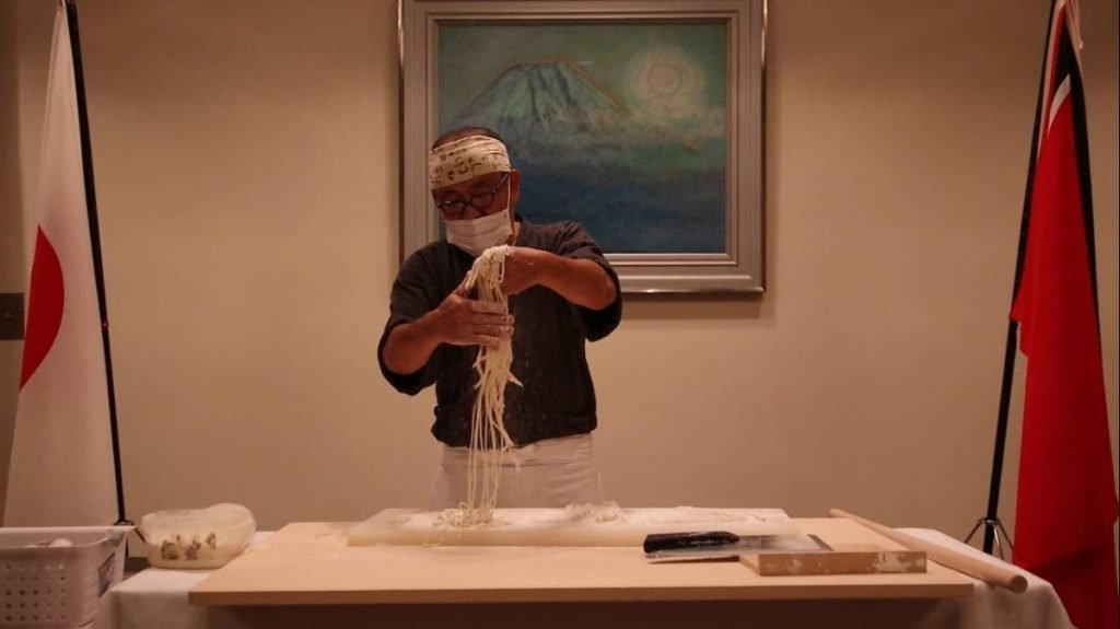 Chef Jinichi Osawa shows guests the hand-made noodles. - 