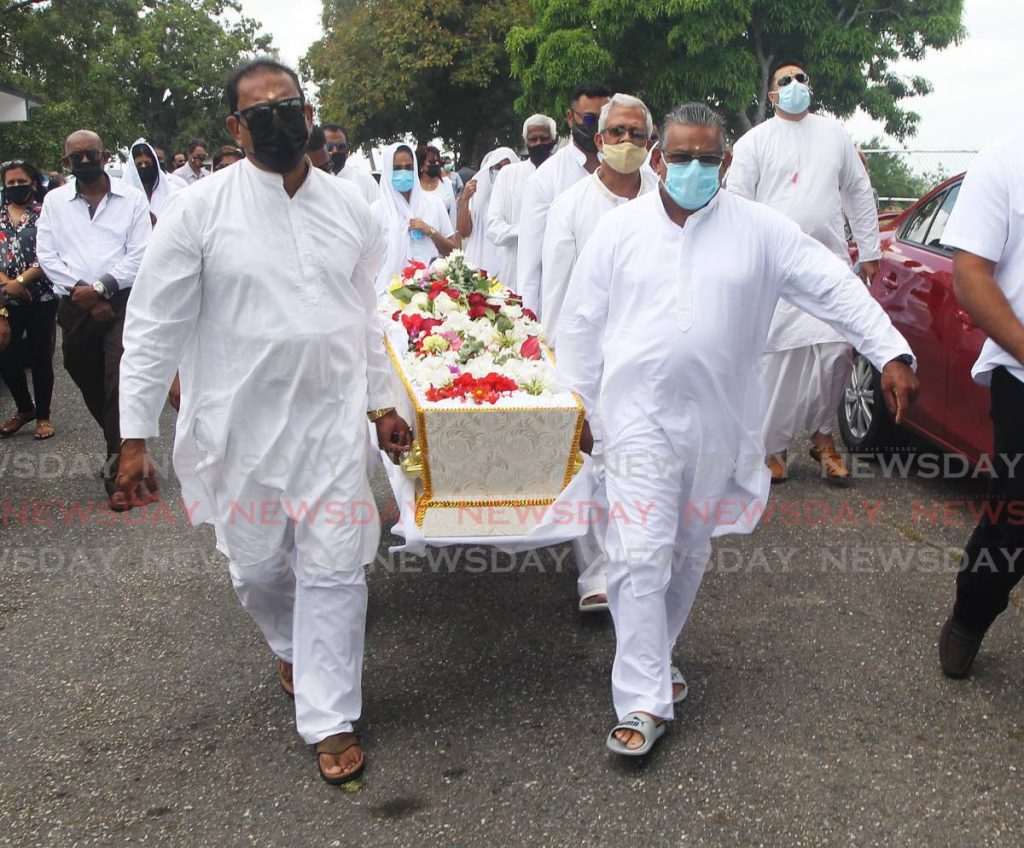 The family of murdered Gasparillo business man Anand Maharaj on their way to perform the final rites. Photo by Lincoln Holder