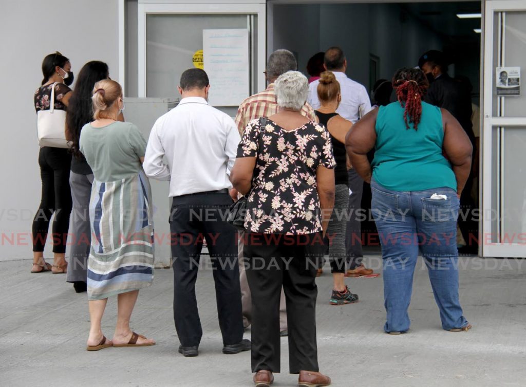 People wait outside the Diego Martin Health Centre to receive the first dose of the AstraZeneca vaccine. Photo by Ayanna Kinsale - AYANNA KINSALE