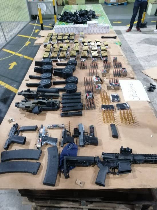 SEIZED: Some of the arms and ammunition seized on Monday from a warehouse in Couva. Photo courtesy TTPS - 