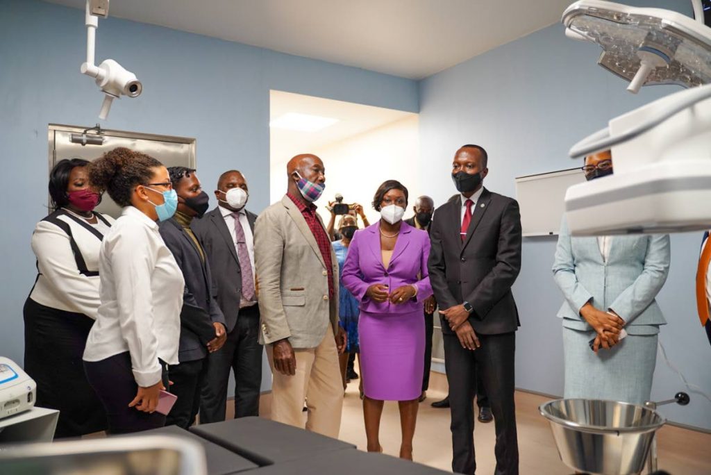 Prime Minister Dr Keith Rowley, centre, tours the Roxborough Health Facility with Chief Secretary Ancil Dennis, Health Secretary Tracy Davidson-Celestine and other officials at its commissioning in January. PHOTO COURTESY THA - 