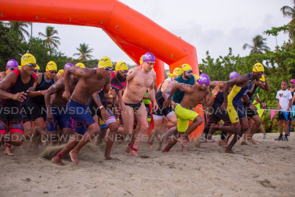 In this file photo, Athletes race to the water to start the swimming leg, of the 2019 Rainbow Cup triathlon, held at Turtle Beach,Tobago. The 2021 edition of the Rainbow Cup has been postponed to November 6.  - Photo by David Reid