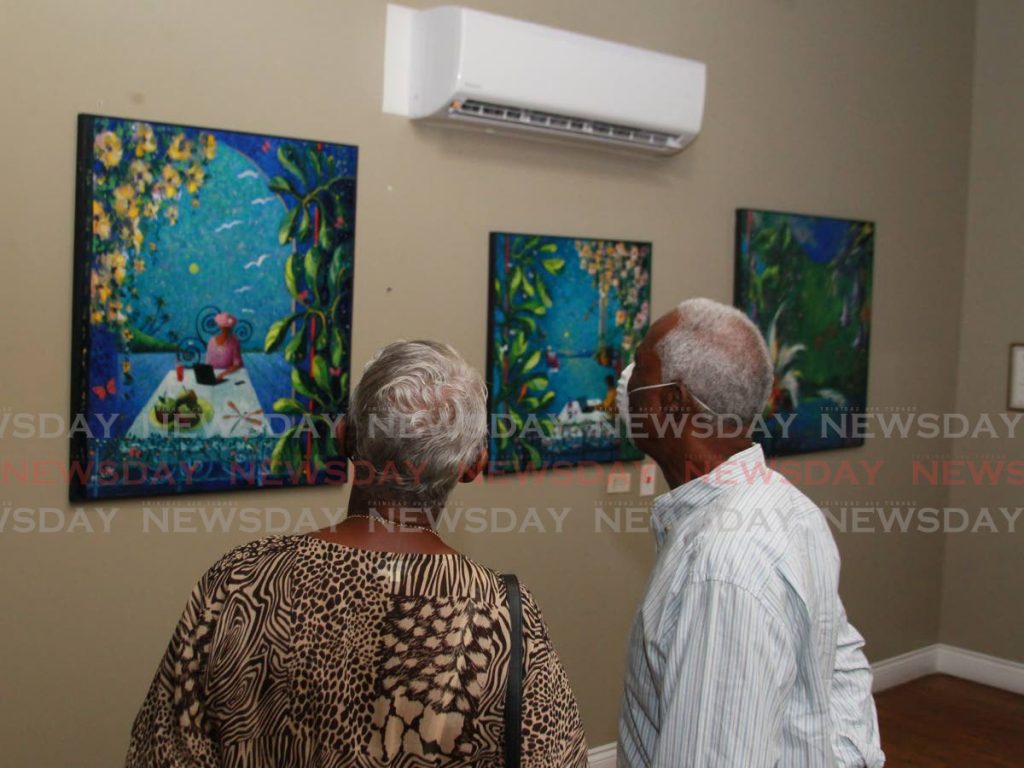 In this file photo, patrons view a collection of paintings by artist Sarah Beckett at Arnim's Art Gallery in February. - Roger Jacob