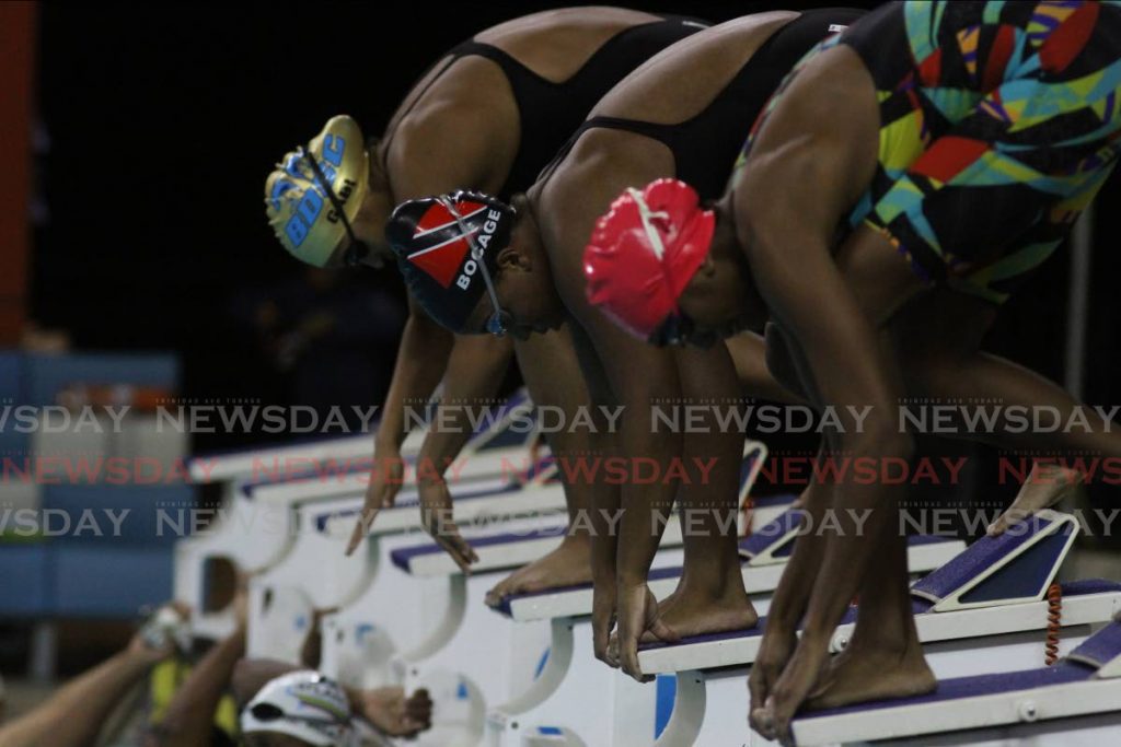 In this February 26, 2021 file photo, Analee Maharaj (left), Lleana Bocage (centre) and Gabriella Acosta prepare to compete in the girls 18-and-over 100-metre breaststroke race, at the National Aquatic Centre, Couva. PHOTO BY MARVIN HAMILTON - Marvin Hamilton