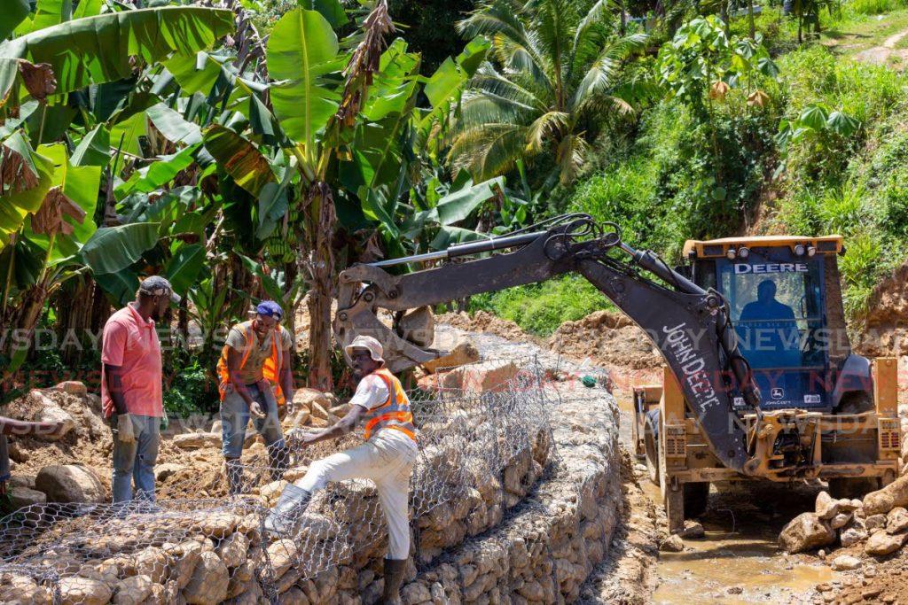 Workers reinforce a riverbank to prevent landslides at Manswell Trace, Castara Village, Tobago. Tobagonians have called for a larger allocation of the national budget. Photo by David Reid