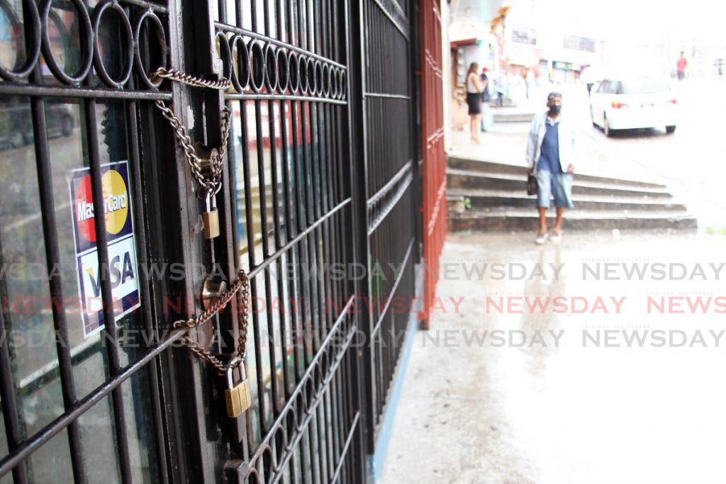 Chained gates litter High street San Fernando as only essential services are allowed to remain open as more restrictions were implemented to curb the spread of the covid 19 virus. Photos by Lincoln Holder
