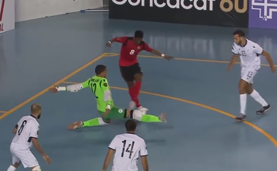 Trinidad and Tobago's Jameel Neptune dribbles the Dominican Republic goalie to score a consolation in a 6-2 defeat in the Concacaf Futsal Championship on Tuesday.  
