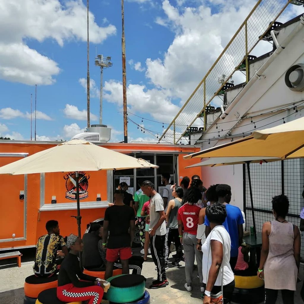 People wait to purchase food prepared by Michel Peters in his food truck in Barataria. Photo courtesy Michel Peters - 
