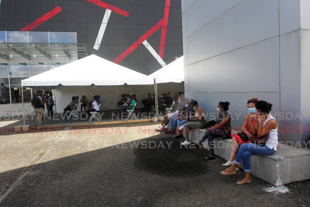 In this May 6 file photo, people await covid19 vaccines at SAPA, San Fernando. Photo by  Lincoln Holder