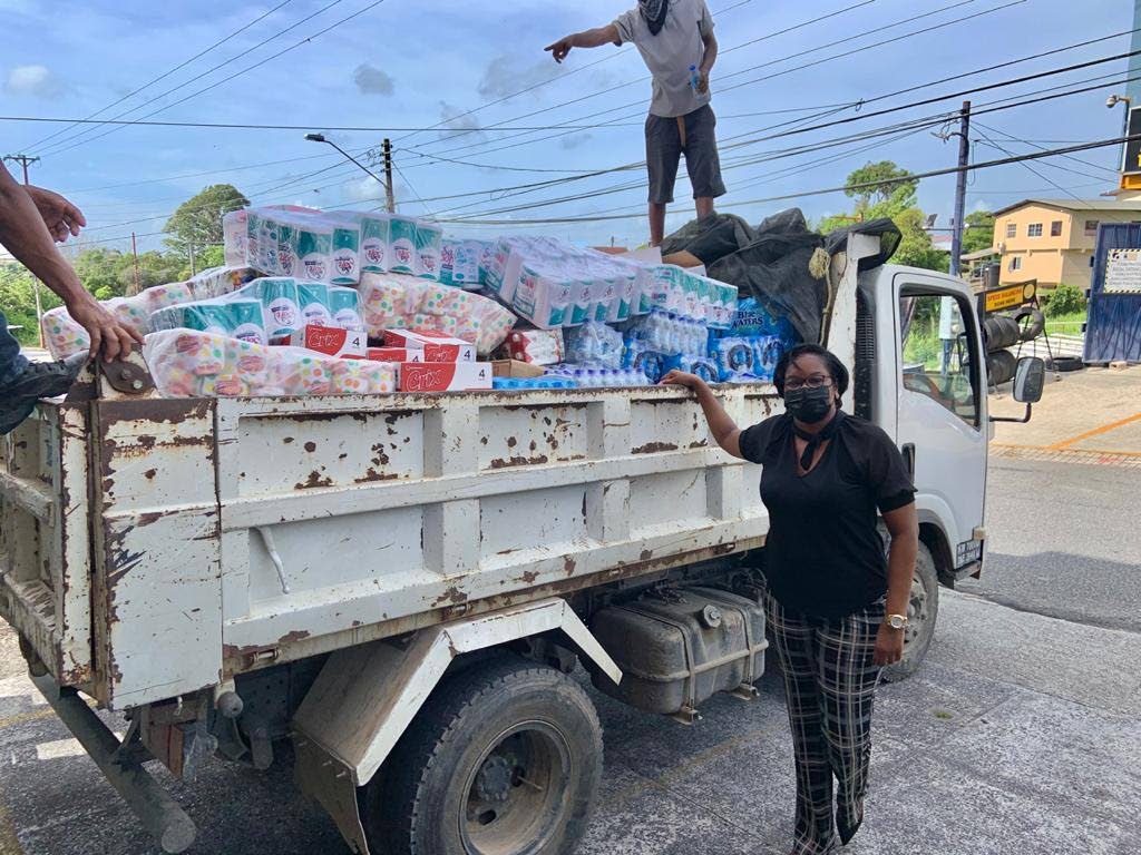 San Fernando East PNM constituency chairman Patricia Alexis sends off a truck loaded with supplies collected at the PNM South Regional Office. 
