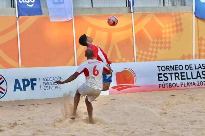 TT beach soccer player Ryan Augustine challenges a Paraguay player during Tuesday's friendly match at the Estadio Mundialista Los Pynandi, Luque, Gran Asuncion, Paraguay.

PHOTO COURTESY TT FOOTBALL ASSOCIATION. - 