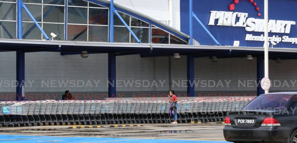 Is Pricesmart open? A woman asked a security personnel outside the Port of Spain branch. Photo by Sureash Cholai