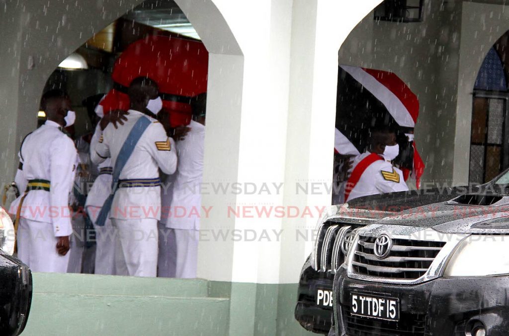 Members of the Defence Force carry the body of former minister of energy Franklin Khan out of the Aramayala Presbyterian Church in Tunapuna at his funeral service on Saturday. - Photo by Angelo Marcelle