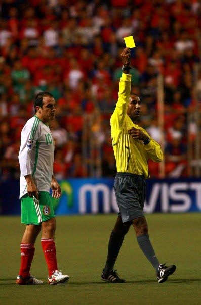 Neal Brizan (right) issues a yellow card during a 2009 match between Costa Rica and Mexico at San Jose, Costa Rica. Also in photo is Mexico striker Cuauhtémoc Blanco. - 