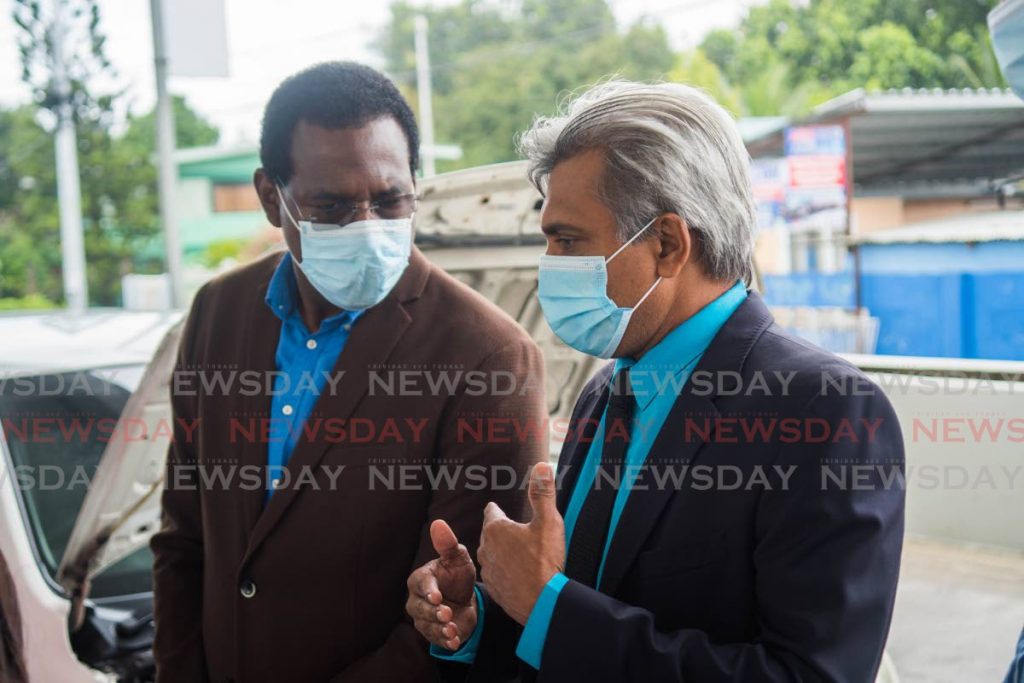 Curtis Mohammed, President NGC CNG (right) explains the calibration exercise to Unipet CEO Dexter Riley. - NGC CNG