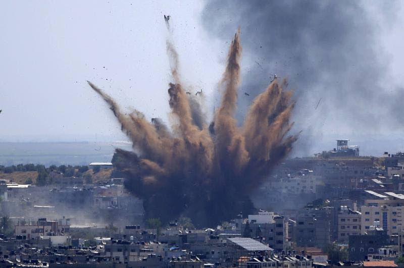 Smoke rises following Israeli air strikes on a building in Gaza City on May 13, 2021. - AP Photo
