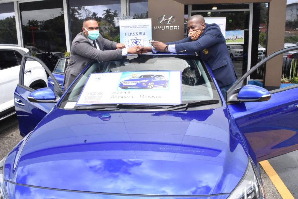 Grand prize winner of the TTPS Social Welfare Association's car raffle Anthony Harris, left, poses with association president Insp Gideon Dickson near the grand prize, a Hyundai Ioniq car at Xtra Plaza, Chaguanas, in April. 

PHOTO COURTESY TTPSSWA - PHOTO COURTESY TTPSSWA