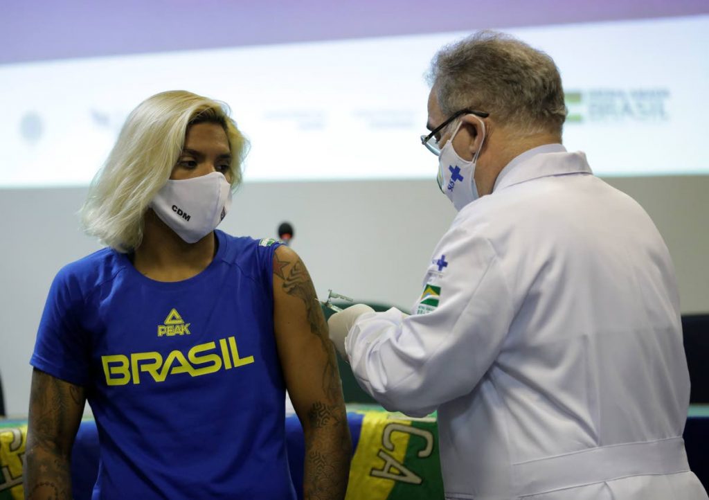 Brazilian swimmer Marcela Cunha (left) gets a shot of the Pfizer vaccine for covid19 from Health Minister Marcelo Queiroga at Urca military base in Rio de Janeiro, Brazil, on Friday. (AP PHOTO)