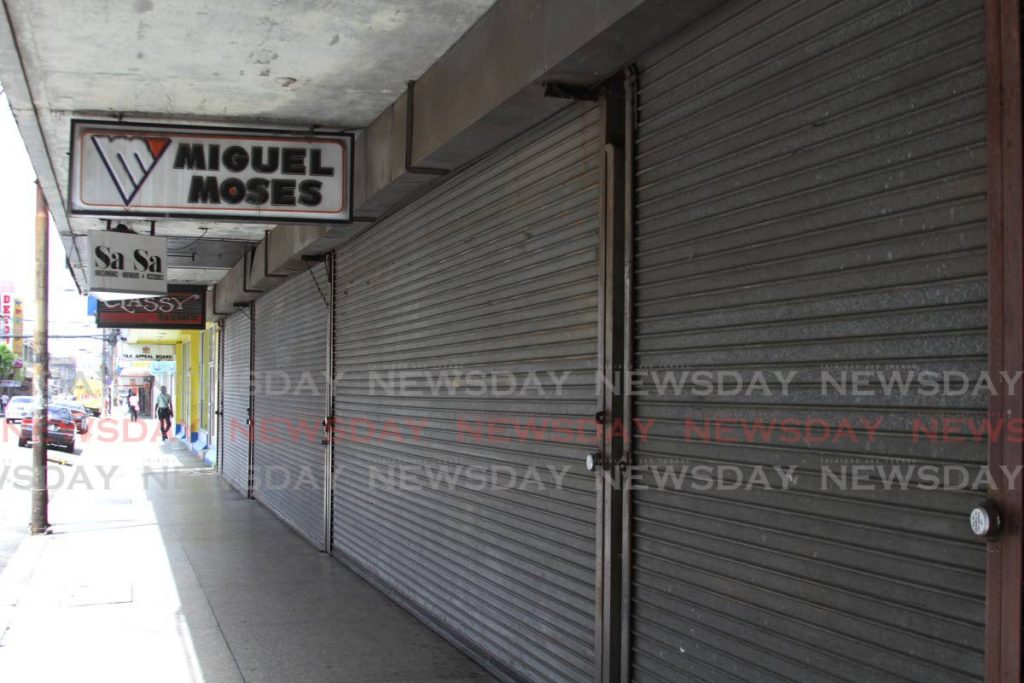 In a scene more reminiscent of a public holiday than a regular Tuesday, stores on Frederick St, Port of Spain are shuttered. - Marvin Hamilton