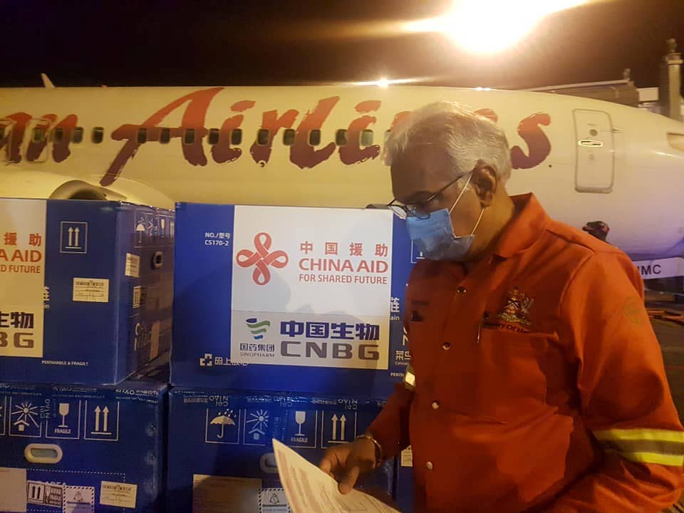 Health Minister Terrence Deyalsingh receives the 100,000 Sinopharm vaccines donated by the Government of China. The vaccines arrived in Trinidad and Tobago early Wednesday morning. - PHOTO COURTESY THE MINISTRY OF HEALTH