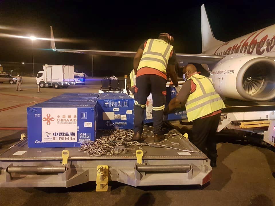 Airport workers offload the Sinopharm vaccines which arrived in Trinidad and Tobago from China on Wednesday morning. - PHOTO COURTESY THE MINISTRY OF HEALTH