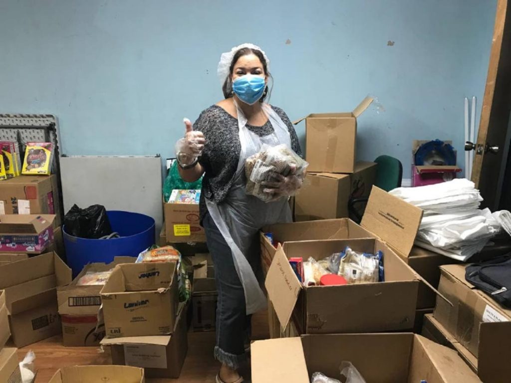 KIND member helps with  covid19 relief hamper packing. - 