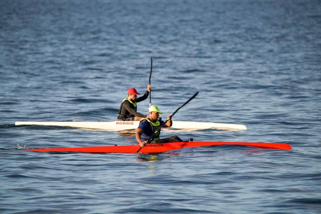 Siblings Matthew Robinson, front, and Nicholas Robinson train at Williams Bay, Chaguaramas in an attempt to qualify for the Olympic Games canoe sprint event. 