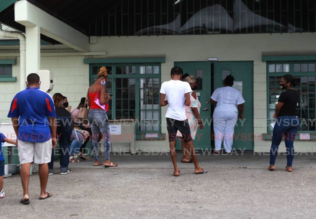 Several people wait at the La Horquetta Health Centre on the first day of the Sinopharm vaccination rollout. - Photo by Roger Jacob
