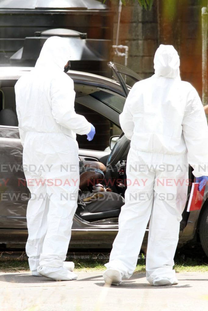 CSI collect evidence surrounding the murder of air condition technition Angus Noel 31, at Arena Road, Freeport on Tuesday. Noel was killed in his vehicle as he was about to drive off.   PHOTO:ANGELO M. MARCELLE 25-05-2021 - Angelo Marcelle
