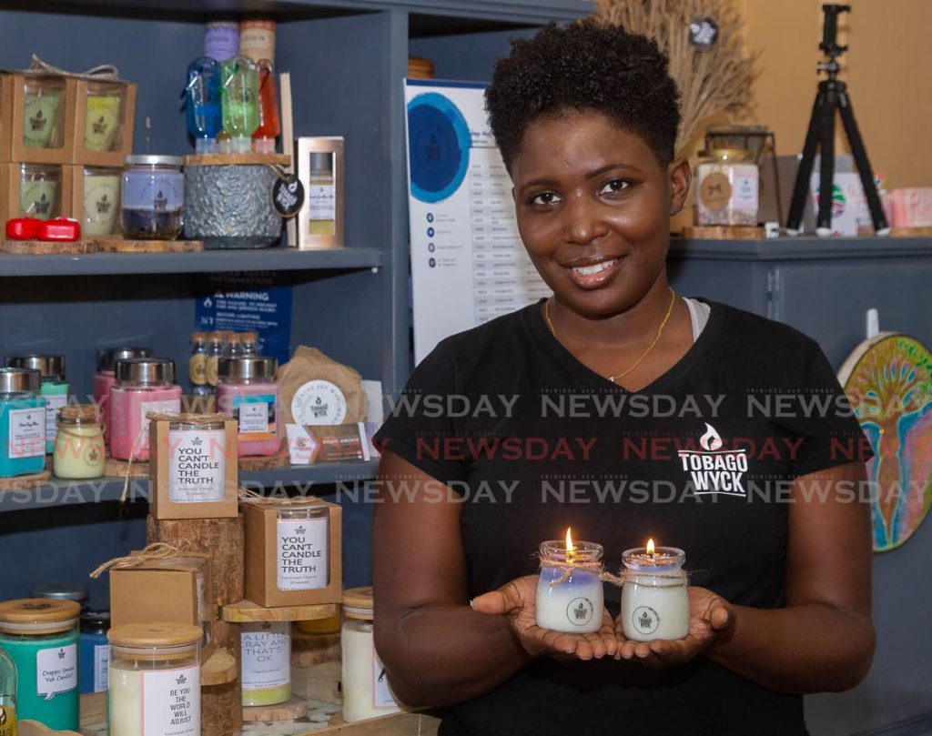 Gizelle Drue, owner of Tobago Wyck, shows some of her scented candles which capture Tobago’s essences.  PHOTO BY DAVID REID - DAVID REID 